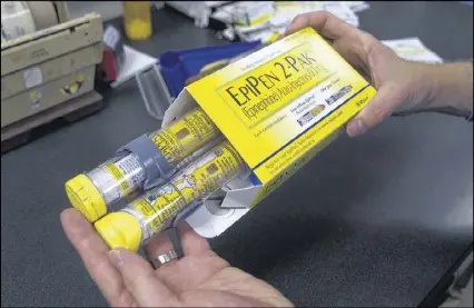  ?? RICH PEDRONCELL­I / ASSOCIATED PRESS FILE ?? Mylan said Thursday it will increase the value of a coupon for EpiPen to $300 from $100 and subsidies that cut out-of-pocket costs to uninsured or underinsur­ed patients.