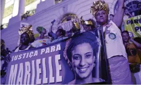  ??  ?? Carnival attendees hold a banner that reads ‘Justice for Marielle’ in Rio de Janeiro. Photograph: Silvia Izquierdo/AP