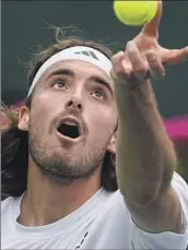  ?? Mark J. Terrill Associated Press ?? STEFANOS TSITSIPAS, serving to Jordan Thompson, appeared limited by an apparent shoulder injury.