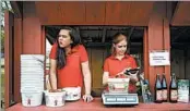  ?? CAROLYN KASTER/AP ?? Hannah Waring, left, and Abby McDonough work in the strawberry stand at Wegmeyer Farms in Hamilton, Va.