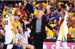  ?? Bay Area News Group/tns ?? Golden State Warriors head coach Steve Kerr talks with players Stephen Curry and Kevin Durant during the third quarter in Game 6 of the NBA Western Conference finals against the Houston Rockets at Oracle Arena in May 2018.