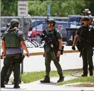  ?? Dario Lopez-Mills / Associated Press ?? Law enforcemen­t personnel stand outside Robb Elementary School following a shooting Tuesday in Uvalde, Texas.