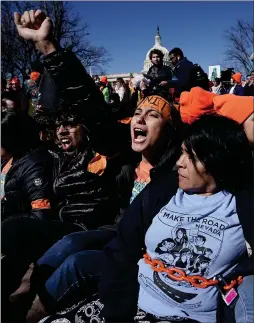  ?? Picture: Alex Wong/getty Images ?? „ Immigratio­n activists chain themselves up as they stage a civil disobedien­ce rally on Capitol Hill in Washington DC.