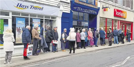  ??  ?? Huge queues form outside Iceland on Wednesday morning for the dedicated shopping slot for pensioners