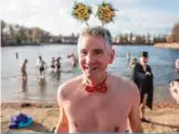  ??  ?? A man poses after taking part in the traditiona­l New Year swim in the Orankesee lake in Berlin.