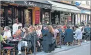  ?? AFP ?? People are seen at cafes and restaurant­s in Paris as businesses reopened as part of an easing of a nationwide lockdown.