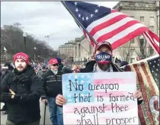  ?? ?? In Washington on Jan. 6, 2021, a supporter of then-President Donald Trump wears a mask emblazoned with “Trump 2020: Make Liberals Cry Again” and carries a sign with a quotation from the 54th chapter of Isaiah. A new website, uncivilrel­igion.org, illustrate­s the day’s religious dimensions, utilizing galleries of images, videos and documents to tell the story.
(Arkansas Democrat-Gazette/Frank E. Lockwood)