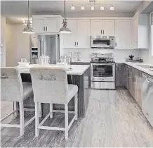  ??  ?? Quartz counters and luxury vinyl plank flooring are among the features.