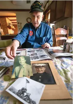  ?? Stuart Villanueva/The Galveston County Daily News via AP ?? ■ Marine veteran Ivan Hammond sorts through photograph­s and memorabili­a March 5 at his house in Santa Fe, Texas, from his years of service during World War II. Hammond fought at the Battle of Iwo Jima.