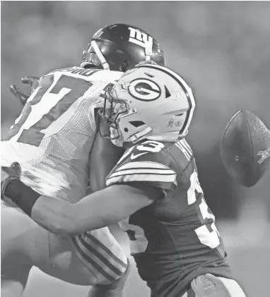  ?? RICK WOOD / MILWAUKEE JOURNAL SENTINEL ?? Packers defensive back Micah Hyde breaks up a pass to Sterling Shepard in Green Bay’s victory Oct. 9 over the Giants.