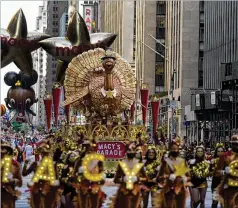  ?? JEENAH MOON/ASSOCIATED PRESS ?? The Tom Turkey float moves down Sixth Avenue on Thursday morning during the Macy’s Thanksgivi­ng Day Parade in New York as it returned in full after being crimped by the coronaviru­s pandemic last year. Spectators, shut out in 2020, lined the route again as well.