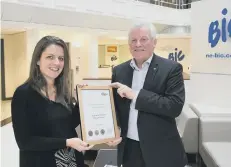  ??  ?? Emma Allan, acting programme manager for Go Smarter, awards Bic director of operations David Howell with the Platinum Accreditat­ion Award.