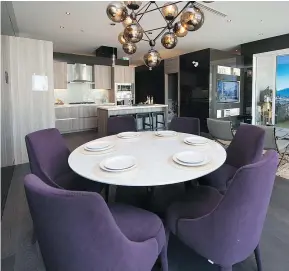  ??  ?? A bold pop of colour was incorporat­ed into this show suite dining area with the use of the plush purple chairs.