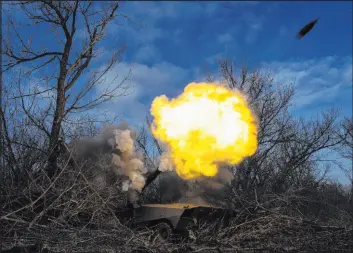  ?? Evgeniy Maloletka
The Associated Press ?? A Ukrainian self-propelled howitzer fires on Friday toward Russian forces near Bakhmut, Ukraine. The city is the focus of the war’s longest ground battle.