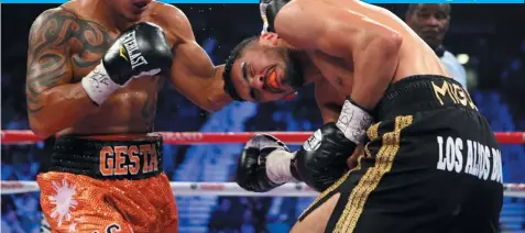  ?? (AFP) ?? Mercito Gesta throws a left at Miguel Angel Vazquez during their IBF world lightweigh­t title fight at the MGM Grand Garden Arena in Las Vegas, Nevada.