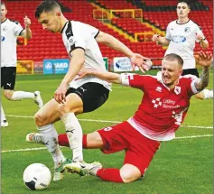  ??  ?? TOUGH ENCOUNTER: Aidan Chippendal­e, right, battles for the ball