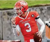  ?? Brett Coomer / Staff photograph­er ?? Sam Houston QB Eric Schmid celebrates scoring a TD in the Bearkats’ comeback vs. James Madison.