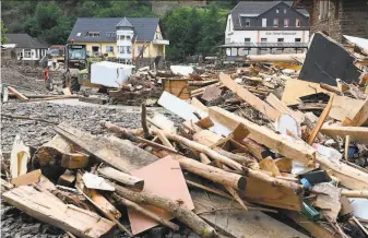  ?? Christof Stache / AFP via Getty Images ?? Debris covers a street in the city of Altenahr in western Germany. Warnings of potentiall­y catastroph­ic flooding didn’t appear to have made it to many people in affected areas.