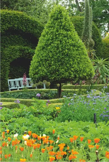  ??  ?? Above left: The Kitchen Garden with its softly sculpted yew hedges and boxedged beds. Left: One of a pair of ogeeroofed pavilions designed by Simpson &amp; Brown. Facing page: Across the wildflower meadow towards the ‘female’ pavilion