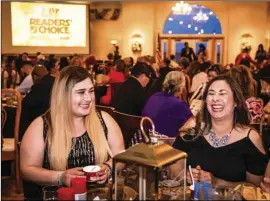  ?? PHOTO VINCENT OSUNA ?? Guests Annabel Ruiz (right) and Reyna Ramirez enjoy the company at their table during the annual Readers’ Choice Gala held Wednesday at the Old Eucalyptus Schoolhous­e in El Centro.