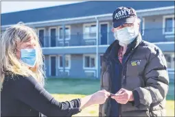  ?? Courtesy photo ?? Ricky Buck receives the key to his apartment at Harmony Village on Wednesday, which was move-in day for several individual­s at the new low-income permanent housing project overseen by Habitat for Humanity Yuba-sutter.