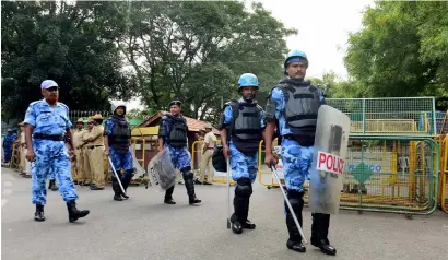  ?? PTI ?? Rapid Action Force personnel patrol at the entrance of Karnataka chief minister’s official residence in Bengaluru after Supreme Court orders to release 6,000 cusecs of water to Tamil Nadu till Friday despite its assembly resolution. —