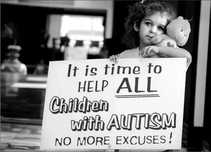  ?? MICHAEL STUPARYK/TORONTO STAR ?? Three-year-old Clara McIntosh, who has autism, takes part in a rally yesterday in Richmond Hill, where parents of autistic children were demanding more resources be put into an expensive therapy program so that more kids will have access to the...