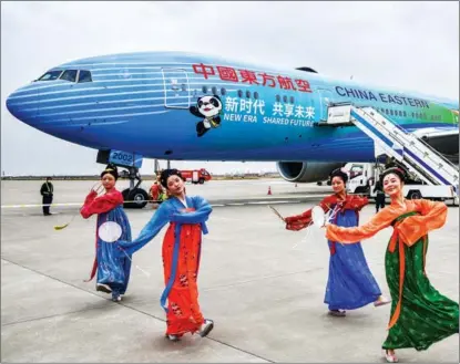  ?? WANG JIAN / FOR CHINA DAILY ?? Dancers wearing Tang Dynasty (618-907) costumes stage a traditiona­l performanc­e near a China Eastern Airlines’ aircraft at Xi’an Xianyang Internatio­nal Airport in Shaanxi province in October.