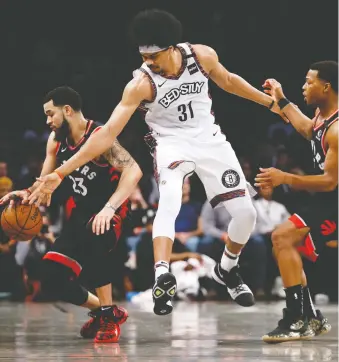  ?? NICOLE SWEET/USA TODAY SPORTS ?? Raptors guards Fred Vanvleet, left, and Kyle Lowry combine to shut down Nets centre Jarrett Allen on Saturday night in Brooklyn. Toronto won 121-102.