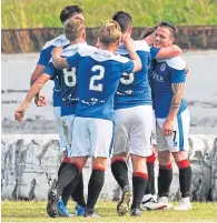  ??  ?? Late joy: The Cowdenbeat­h players celebrate David Cox’s winning goal at Central Park