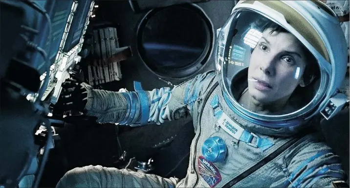 ?? — WARNER BROS. PICTURES ?? Sandra Bullock, shown here in a scene from Gravity, said filming the space drama was like being in solitary confinemen­t.