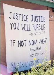  ??  ?? One resident uses a sheet to quote Scripture and leaders in support of Black Lives Matter.