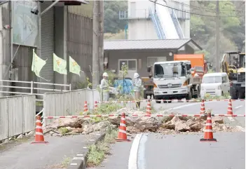  ?? — AFP photo ?? A closed off section of the national highway after rocks fell across the road when a 6.3 magnitude earthquake hit southern Japan, in the city of Ozu, Ehime prefecture.