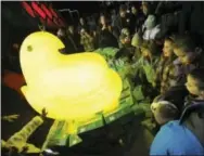  ?? MATT SMITH — THE EXPRESS-TIMES VIA AP, FILE ?? In this file photo, children gather around a large Peep after it was dropped during a New Year’s Eve celebratio­n, at the Levitt Pavillion on the Steelstack­s Campus in Bethlehem, Pa. It’s one of a number of ceremonies in which various objects are...