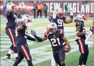  ?? Elise Amendola / Associated Press ?? Patriots defensive back Adrian Phillips, center, celebrates his intercepti­on against the Cardinals on Sunday.