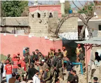  ?? AFP ?? Security personnel gather at the main entrance of the court complex after the Taleban attack. —