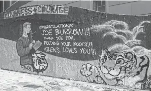 ?? SAM BLACKBURN/TIMES RECORDER ?? A mural congratula­ting Joe Burrow was painted on the Ohio University campus in Athens. Burrow, an Athens High grad, raised awareness to the poverty and hunger issues in Athens County with an emotional Heisman speech, triggering a nationwide fundraisin­g effort that brought more than $500,000 to the Athens County Food Bank.