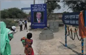  ?? TSERING TOPGYAL — ASSOCIATED PRESS ?? A photograph of U.S. President Donald Trump is displayed at the entrance of Trump Sulabh Village in Maroda, India, Friday. A toilet charity is leading an effort to rename a tiny, north Indian village after President Donald Trump, saying the gesture is...