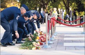  ?? Getty Images ?? U.S. Air Force airmen place flowers during a centennial commemorat­ion event at the Tomb of the Unknown Soldier in Arlington National Cemetery on Wednesday in Arlington, Va.