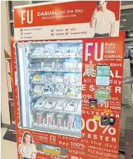  ??  ?? A vending machine for FU brand polo shirts in Bangkok.