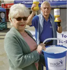  ??  ?? Margaret CampbellWh­ite and Stuart Rowsell, two of the voluteers looking after the Wade stall on Wokingham Market on Saturday Picture: Steve Smyth