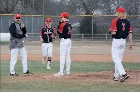  ?? Graham Thomas/Herald-Leader ?? Pea Ridge head coach Matt Easterling (left) walks out to the mound to talk to his players during a game at Siloam Springs on March 7.