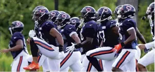  ?? NAM Y. HUH-POOL / GETTY ?? The Bears run drills during training camp on Aug. 18.