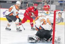  ?? CHARLOTTE CHECKERS PHOTO ?? Lehigh Valley Phantoms goaltender Alex Lyon makes a save on a shot by Charlotte Checkers centre Clark Bishop (11) as Phantoms defenceman Reece Wilcox (44) looks on during their American Hockey League playoff game in Charlotte, N.C., Wednesday night.