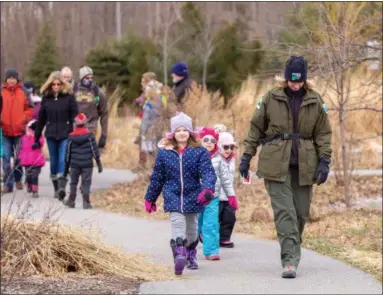  ?? CARRIE GARLAND — THE NEWS-HERALD ?? Visitors of all ages enjoyed the outdoors during Lake Metroparks’ Winter Hike Feb. 10 at Penitentia­ry Glen.