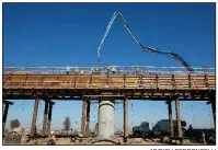  ?? AP/RICH PEDRONCELL­I ?? Workers pour concrete onto an elevated section of the high-speed rail line that will cross the San Joaquin River near Fresno, Calif., in this December photo.