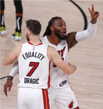  ?? getty imageS ?? BLOWN OPPORTUNIT­Y: Miami’s Jae Crowder and Goran Dragic react after their win over Boston in Game 2 of the Eastern Conference Finals on Thursday night. At right, Kemba Walker drives against Kelly Olynyk during the fourth quarter.