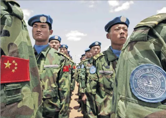  ?? Photo: Stuart Price/AFP ?? Playing their part: Engineers from China’s army, serving with the UN-AU mission in Darfur, arrive in Sudan.