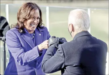  ?? AP photo ?? Vice President Kamala Harris bumps fists with President-elect Joe Biden after she was sworn in during the inaugurati­on Wednesday at the U.S. Capitol in Washington.