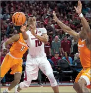  ?? NWA Democrat-Gazette/CHARLIE KAIJO ?? Razorbacks forward Daniel Gafford (10) passes during Saturday’s 95-93 victory against Tennessee at Walton Arena in Fayettevil­le. Arkansas faces Mississipp­i State (12-1, 0-0) and Auburn (12-1, 0-0) this week.